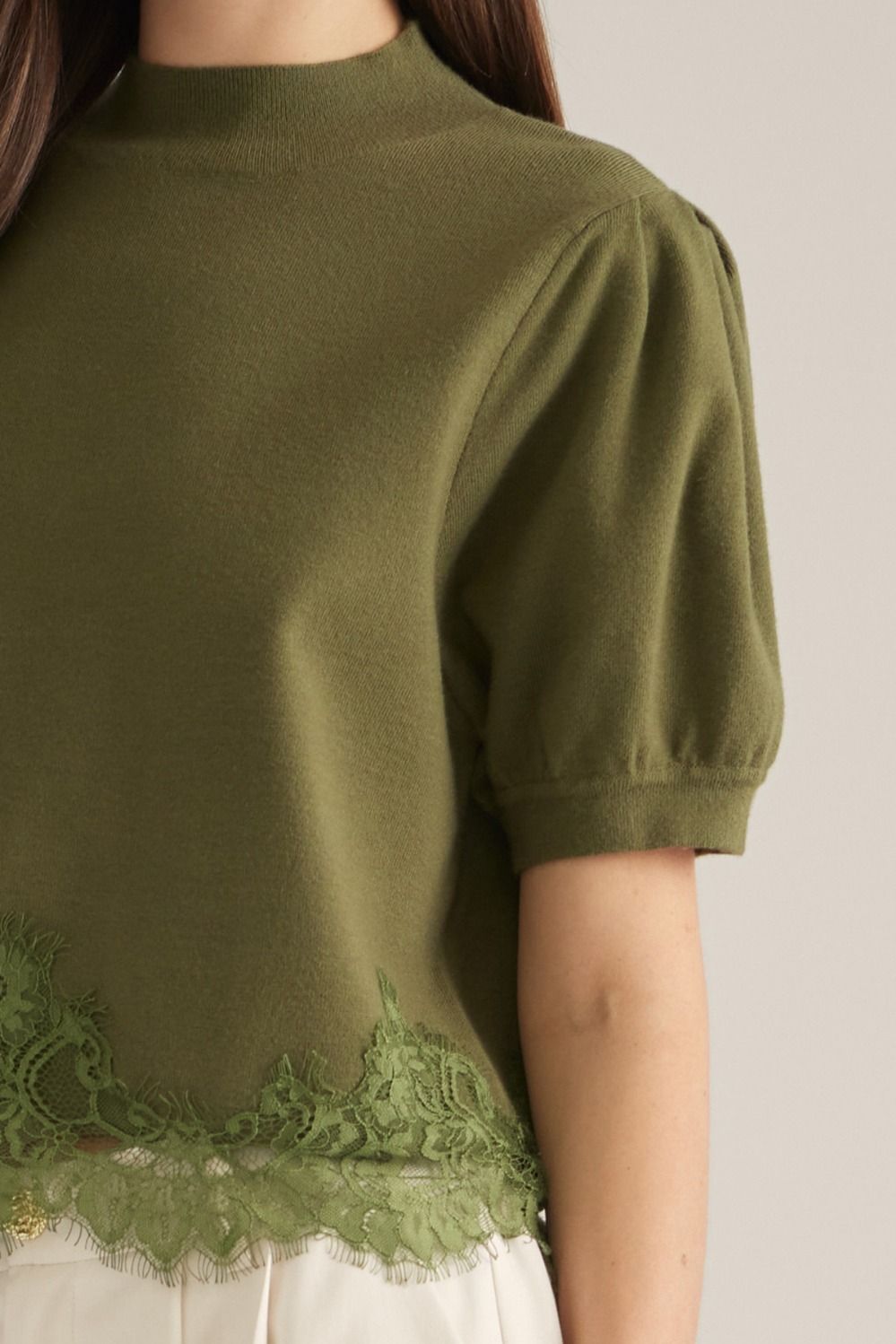 Green puff sleeve sweater with lace bottom detail